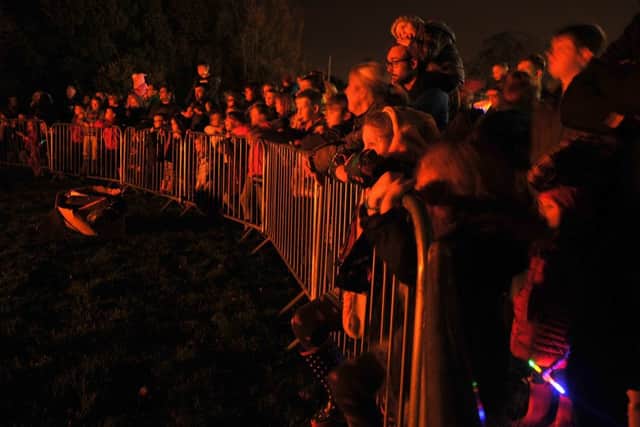 Euxton Cricket Club held a bonfire night as part of Chorley Carnival.
Crowds warm themselves round the bonfire.  PIC BY ROB LOCK
4-11-2015