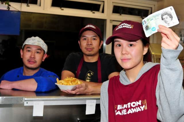 Emma Chan, Cashier at Barton Take Away, Garstang Road, Barton, who was cheated out of five pounds by slight of hand tricksters, pictured with Managers Jen Ben Law and Jen Law