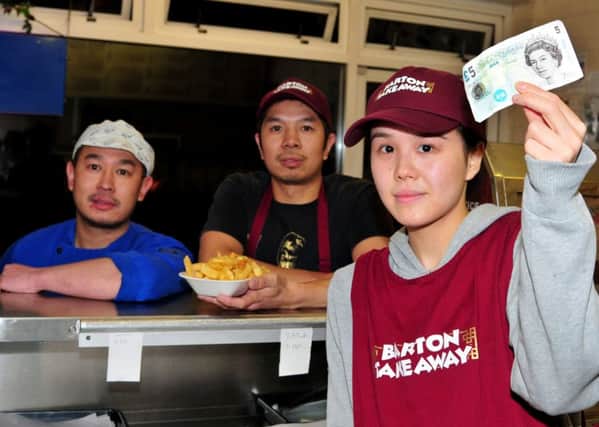 Emma Chan, Cashier at Barton Take Away, Garstang Road, Barton, who was cheated out of five pounds by slight of hand tricksters, pictured with Managers Jen Ben Law and Jen Law