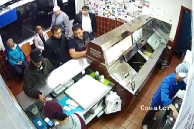 Barton takeaway CCTV showing images of  man conning the cashier into giving him more change.