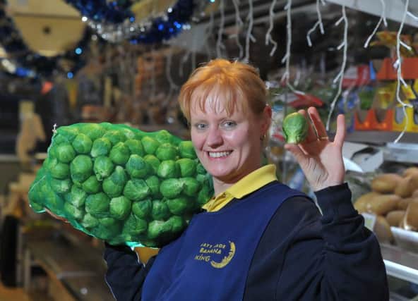 Photo Neil Cross
Siran Petherwick with the XL sprouts on the Banana King stall at Preston Market