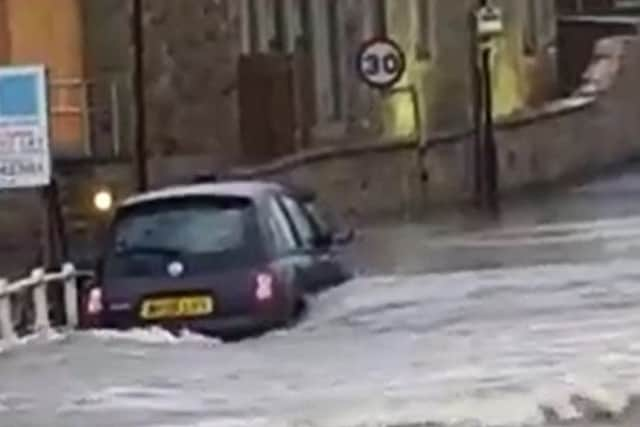 The River Ribble overwhlems a car in the Ribble Valley