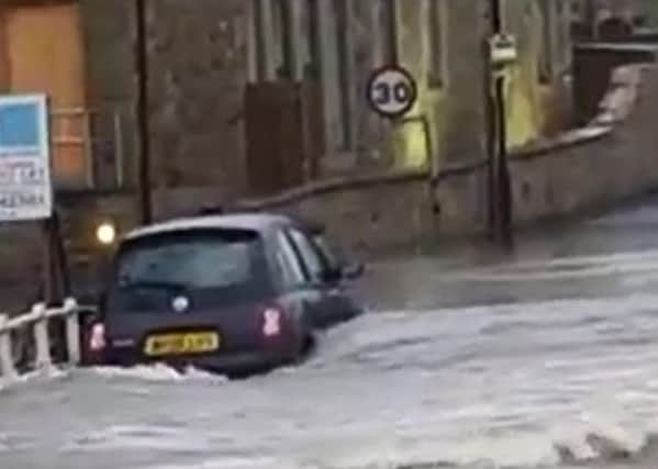 The River Ribble overwhlems a car in the Ribble Valley