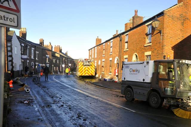 The Lancashire village of Croston was one of the worst affected in the area by the Boxing Day floods. A road sweeper clears mud and debris left by the floodwater.  PIC BY ROB LOCK 27-12-2015
