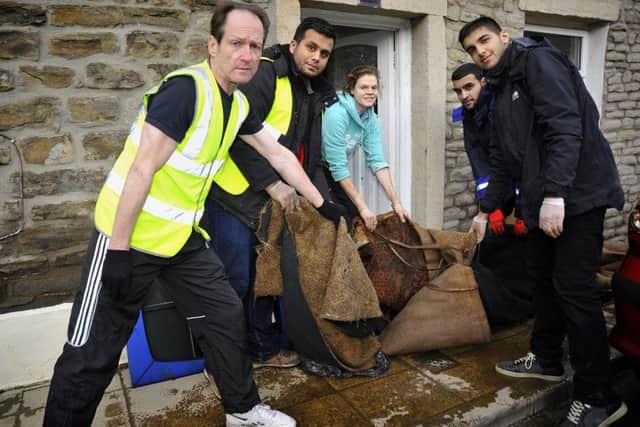 Members of the Ahmadiyya Muslim Youth Association help Lizzy Highton to clear her grandfather's home.  Pic: Rob Lock.