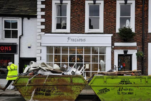 Skips full of ruined furniture and fittings outside businesses on King Street in Whalley.  Pic: Rob Lock.