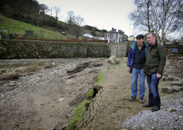 Allan Elliott, of Calder Vale in Whalley, shows MP for Ribble Valley Nigel Evans the spectacular erosion of his garden by the river