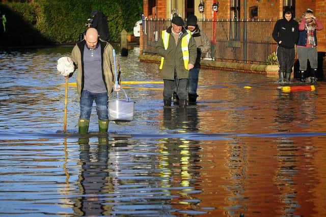 A resident with his mop and bucket in Croston