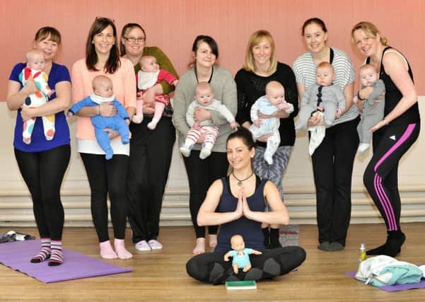The mums and babies with yoga teacher Madeline Diaz Meiners