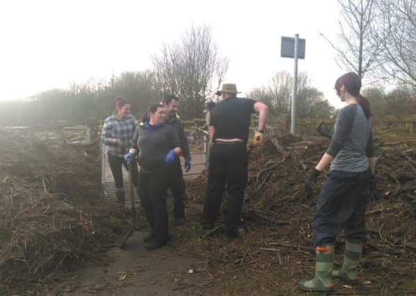 Volunteers clear the Guild Wheel after the flooding. See letter