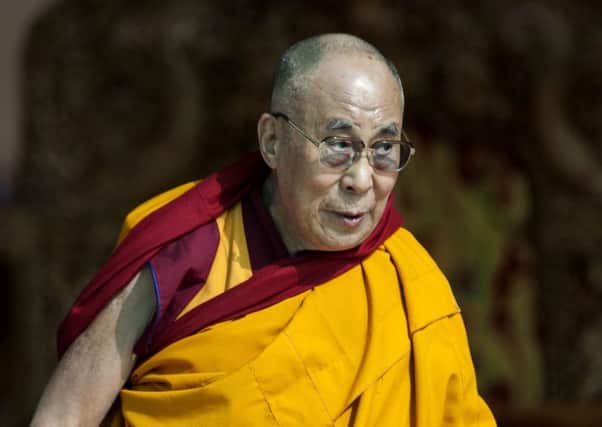 07/07/2014 File photo of the Dalai Lama as he gestures to devotees before he starts teaching on the fifth day of Kalachakra near Leh, India. See PA Feature HEALTH Gallstones. Picture credit should read: AP Photo/Tsering Topgyal/PA Photos. WARNING: This picture must only be used to accompany PA Feature HEALTH Gallstones. UK REGIONAL PAPERS AND MAGAZINES, PLEASE REMOVE FROM ALL COMPUTERS AND ARCHIVES BY 14/02/2015.