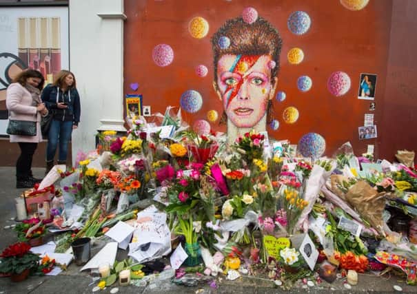 Flowers left at a mural of musician David Bowie, in Brixton, south London, who died this week. See letter on page 17