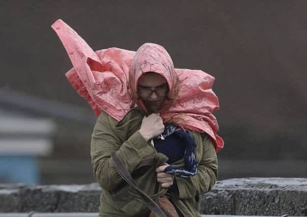 A woman struggles through strong winds and rain (Pic Joe Giddens/PA Wire)