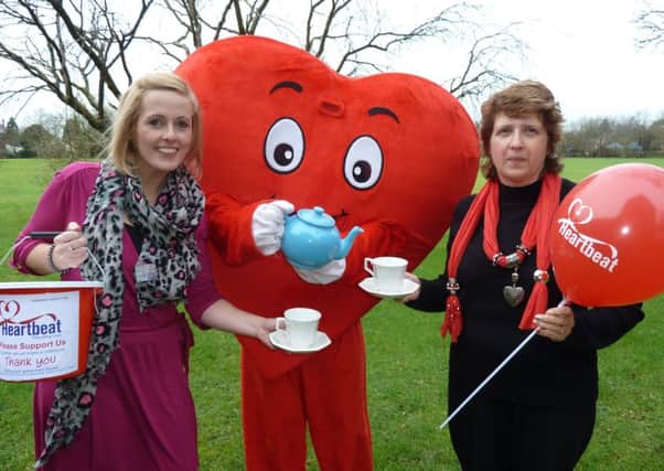 Heartbeat fund-raiser Lisa Riding with mascot Cardiac Carl and the charity's lottery officer, Karen Gildert.