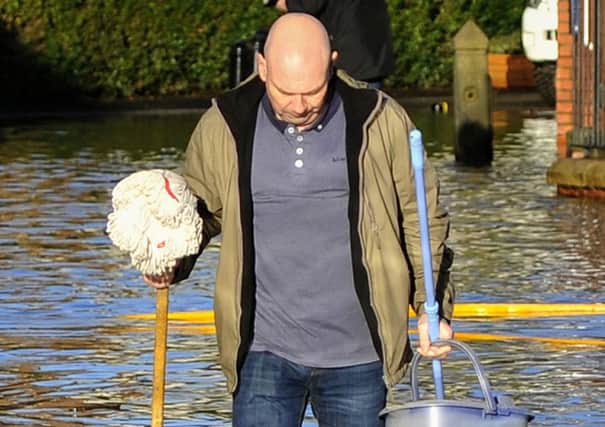 The Lancashire village of Croston was one of the worst affected in the area by the Boxing Day floods.
An ever-optimistic resident with his mop and bucket.  PIC BY ROB LOCK
27-12-2015