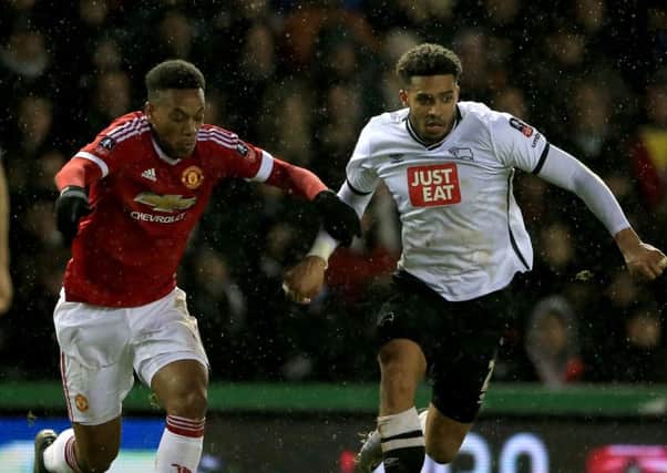 Derby County's Cyrus Christie (right) and Manchester United's Anthony Martial battle for the ball during the FA Cup fourth round match at the iPro Stadium on Friday