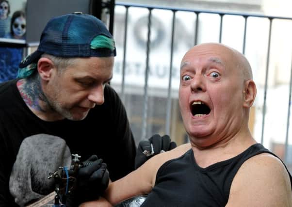 BEING BRAVE: Mel Cartwright goes under the needle to get a tattoo of his sons band