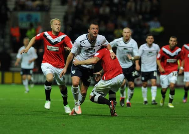 Tom Clarke keeps tabs on Chris Beardsley when PNE defeated Huddersfield in the Capital One Cup in 2012