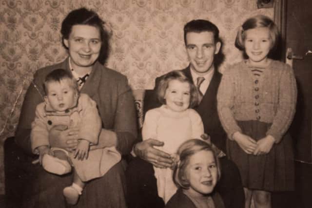 Fiona Sanderson with her parents Dorothy and Gerrard Bateson seated, Fiona is on her mum's knee. Her deceased sister Rose is on her dad's knee.
Older sister Linda is knelt in front and surviving eldest sister Shirley is standing next to her dad.