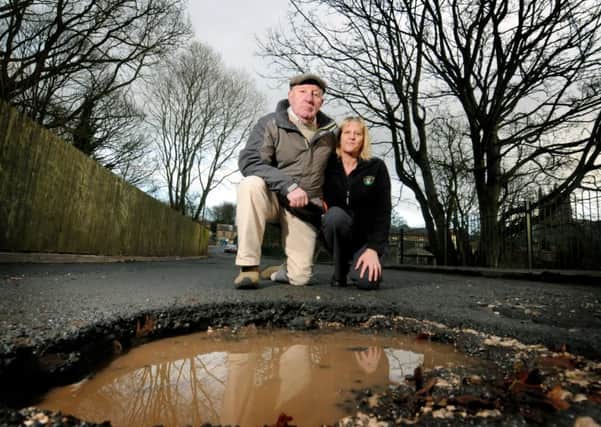 HOLE: Councillor Eric Bell and Sharon Reed inspect the pothole