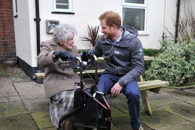 PHOTO NEIL CROSSPrince Harry in St Michaels during a visit to meet local flood victims, with 97 year old Winifred Hodson