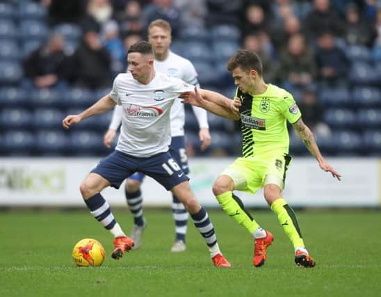 Preston North End's Alan Browne battles with  Huddersfield Town's Jamie Paterson