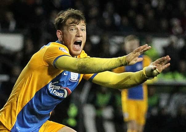 Joe Garner appeals for a penalty at Derby after tumbling in the box