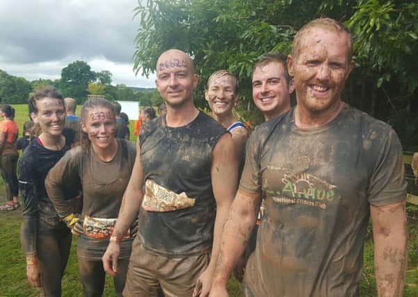Tom Pridgeon, front right, with members of last year's Tough Mudder team.