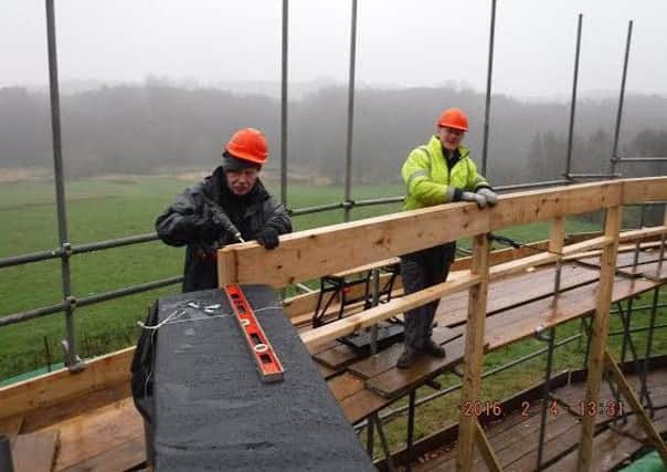 Volunteers Pete Welsh and Martin Harrison battling the elements at the visitor centre.