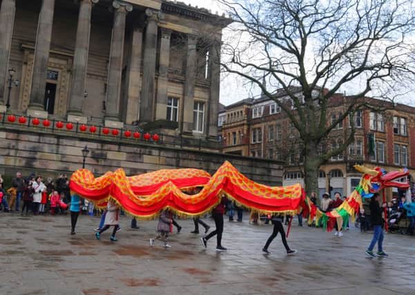 LEP - PRESTON - 13-02-16
Dragon dancing at Flag Market
Families jion in with arts, crafts inside Harris Museum and watch dragon dancing at the Flag Market, part of the Chinese New Year celebrations in Preston city centre.