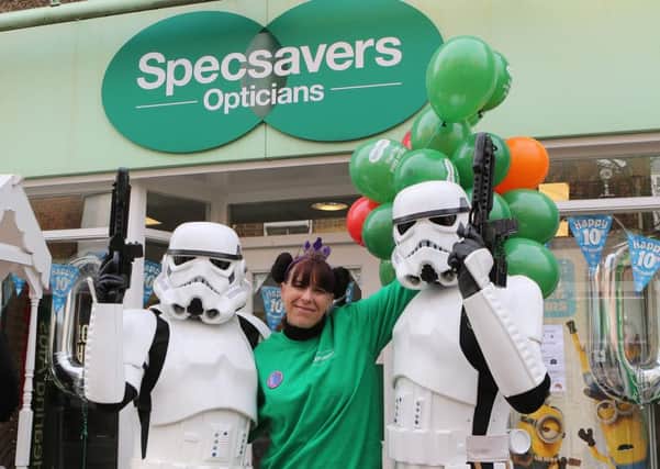 Annie Fletcher of Belper's Specsavers celebrates the shops tenth anniversary helped by a pair of Imperial Stormtroopers