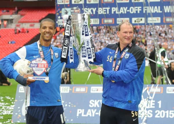 Simon Grayson lifts the League One play-off final trophy with Jermaine Beckford