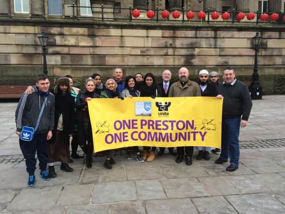 A group of people including the Vicar of Preston Father Timothy, PCC leader Peter Rankin, Chris Lomax from Preston and South Ribble Trades Association, Peter Lumsden, representatives from Preston's Mosques holding the 'One Preston, One Community', Community Celebration banner