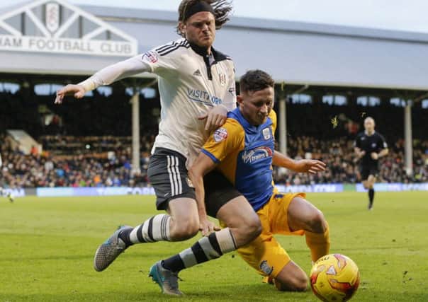 Alan Browne holds off a challenge from Fulham's Richard Stearman