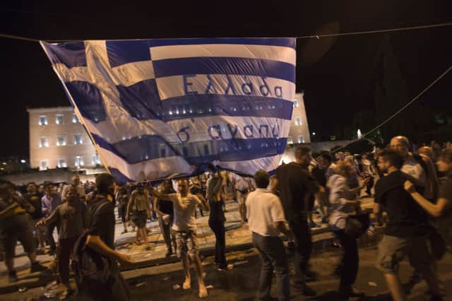 Protesters scuffle with each other in Greece. A reader says the EU enforced austerity on the Greeks, causing poverty. See letter