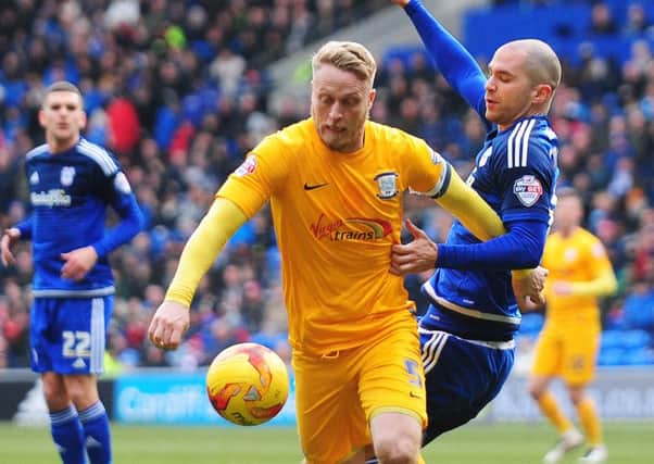 Tom Clarke under pressure from Cardiff City's Matthew Connolly