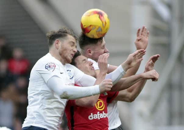Joe Garner and Alan Browne jump with Corry Evans during PNE's meeting with Blackburn at Deepdale in November