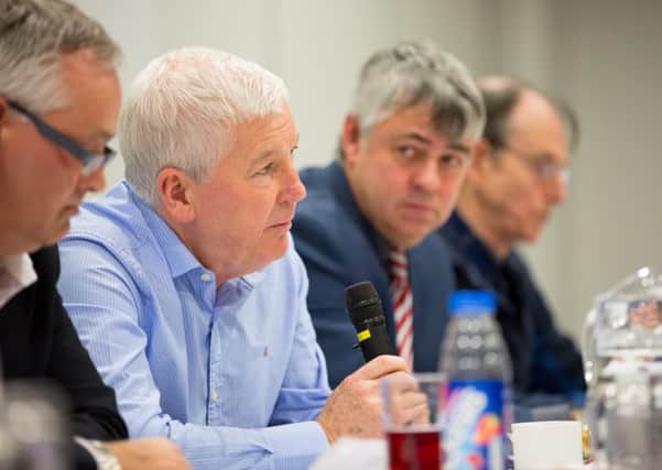 Peter McGuigan, centre, with general manager Mark Dixon left, and vice-chairman Nigel Adams, right.