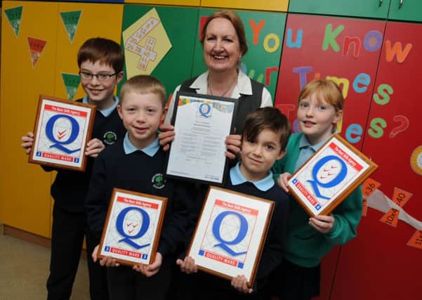 LEYLAND  29-02-16
Janis Burdin, headteacher at Leyland Moss Side Primary School, celebrates as the school has been awarded the Basic Skills Agency Award for the 7th time, pictured with pupils, from left, James Davis, ten, Owen Whittaker, nine, Ben Cockcroft, eight, and Faye Vernon, 11.