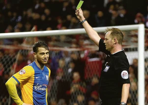Joe Garner is shown a yellow card at the City Ground