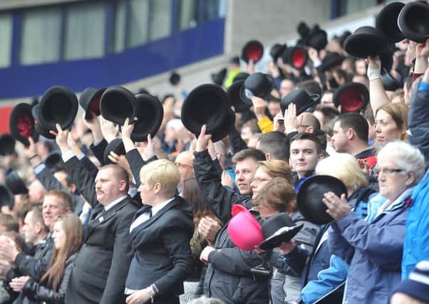 PNE fans wave their bowler hats in the 33rd minute at Bolton