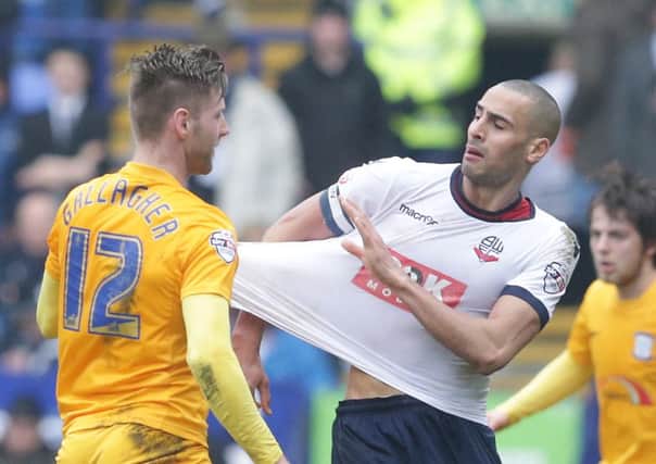 Paul Gallagher tugs the shirt of Bolton's Darren Pratley resulting in both players receiving a yellow card