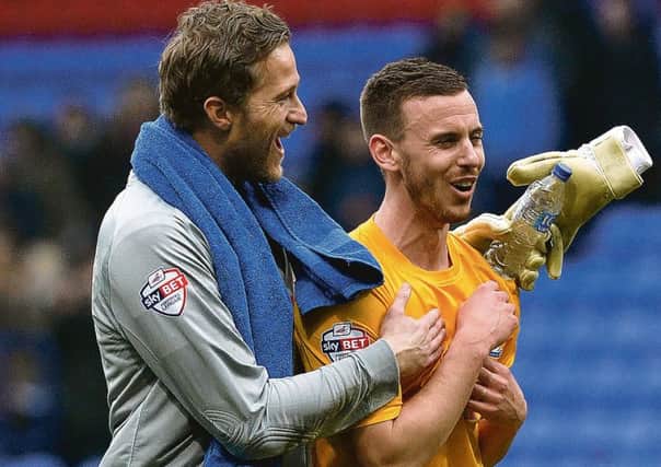 Marnick Vermijl (right) celebrates PNE's win at Bolton with Anders Lindegaard