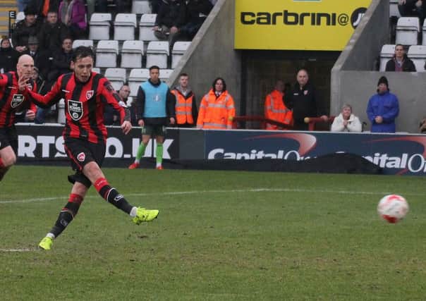 Jamie Devitt scores from the penalty spot to double Morecambe's lead on Saturday.