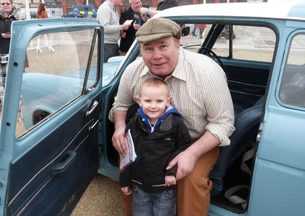 Actor David Lonsdale taken on the Comedy Carpet in the old cop car