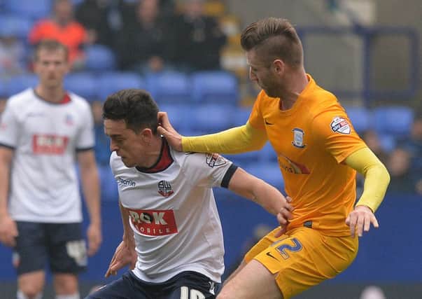 Zach Clough of Bolton battles with Preston North End ace Paul Gallagher