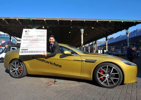 Could it be you?: Hardeep Karir in the  one-off, specially designed gold Aston Martin in Preston