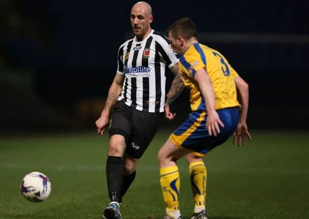 Chorley's James Dean and Lancaster's Gavin Clark in action during the LFA Challenge Trophy final