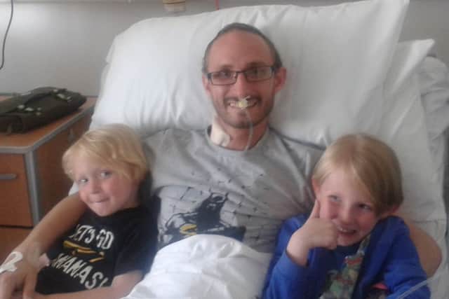 Ric Clark with his kids after his stomach operation