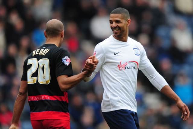 Jermaine Beckford exchanges a word with QPR's Karl Henry